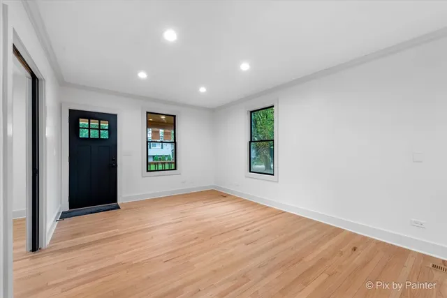 an empty room with windows and closet