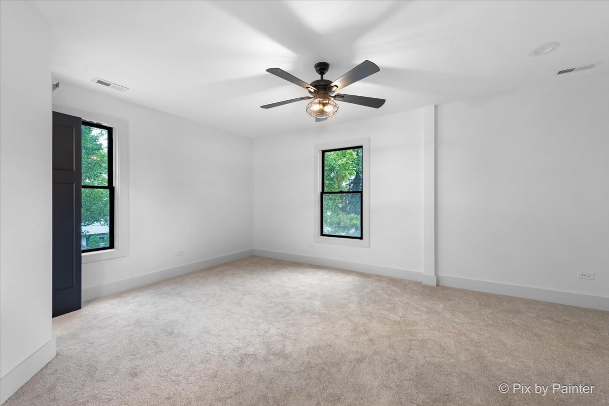 518 Illinois Street Geneva, IL 60134 - Photo 19 of 41 an empty room with windows and fan