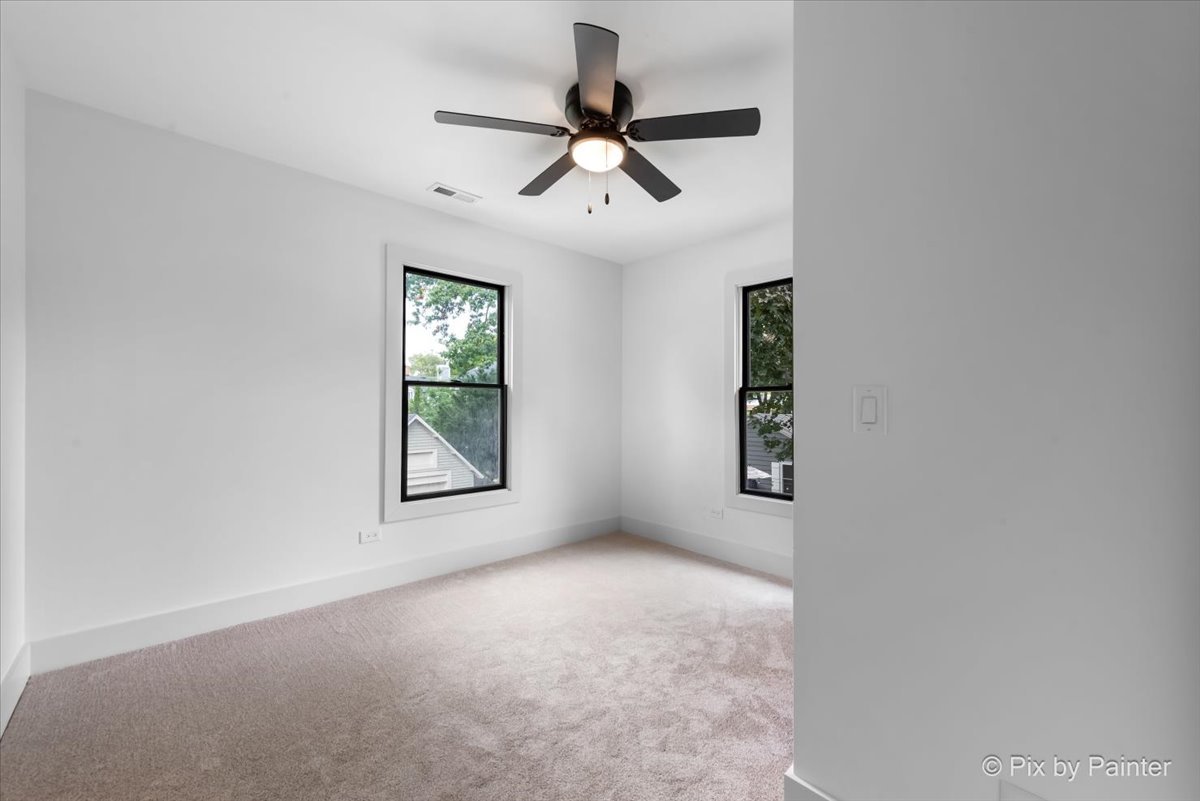 518 Illinois Street Geneva, IL 60134 - Photo 25 of 41 an empty room with windows and ceiling fan