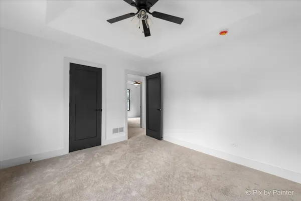a view of a room with a ceiling fan