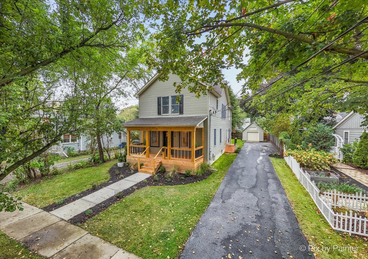 518 Illinois Street Geneva, IL 60134 - Photo 35 of 41 a front view of a house with a yard table and chairs