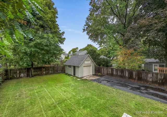 a view of a house with a yard and sitting area