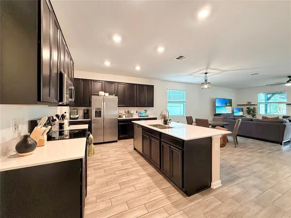 a kitchen with refrigerator cabinets and wooden floor