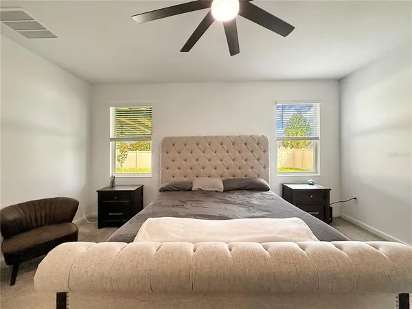 a view of walk in closet with clothes