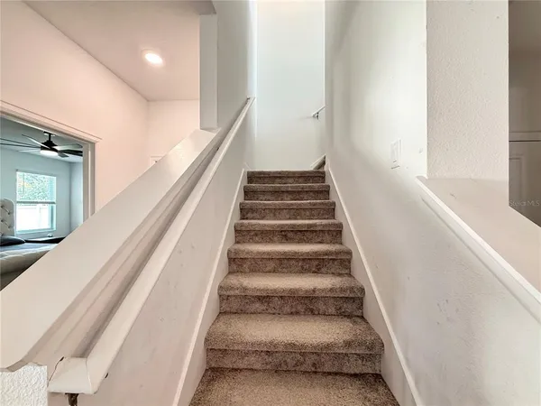 a view of a livingroom with a window and furniture