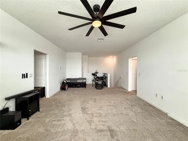 a view of a porch with a table and chairs