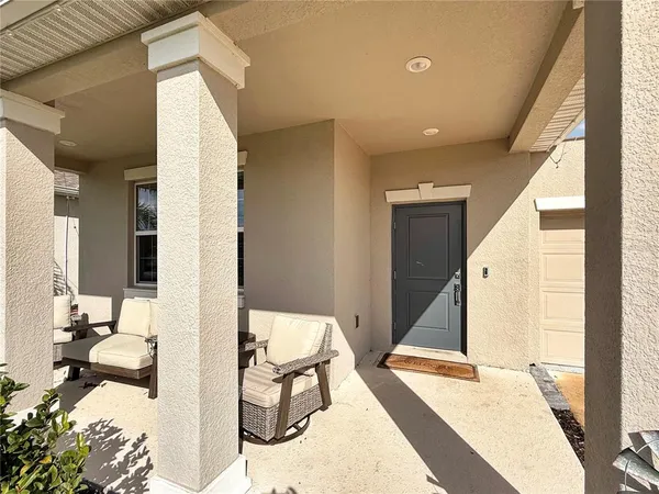 a view of a dining room with furniture a chandelier and wooden floor