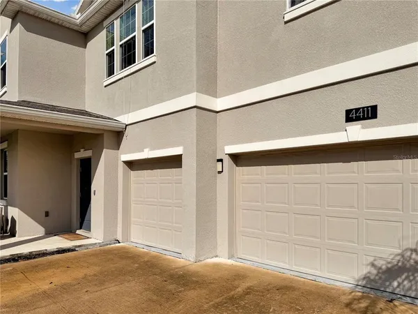 a view of a dining room with furniture a rug and wooden floor