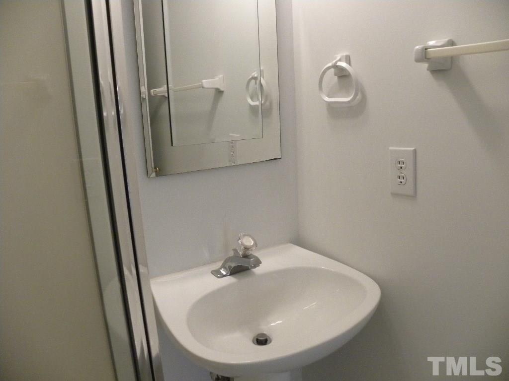 1238 Shadow Bark Court Raleigh, NC 27603 - Photo 12 of 17 a bathroom with a sink and mirror