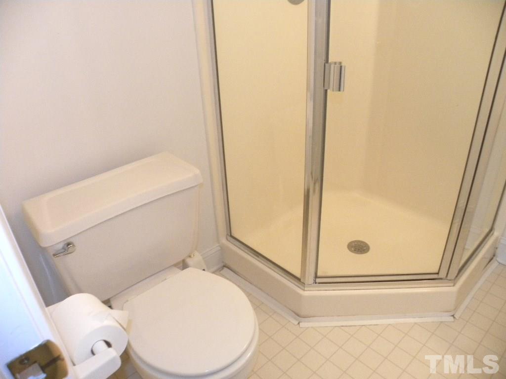 1238 Shadow Bark Court Raleigh, NC 27603 - Photo 13 of 17 a white toilet sitting next to a shower