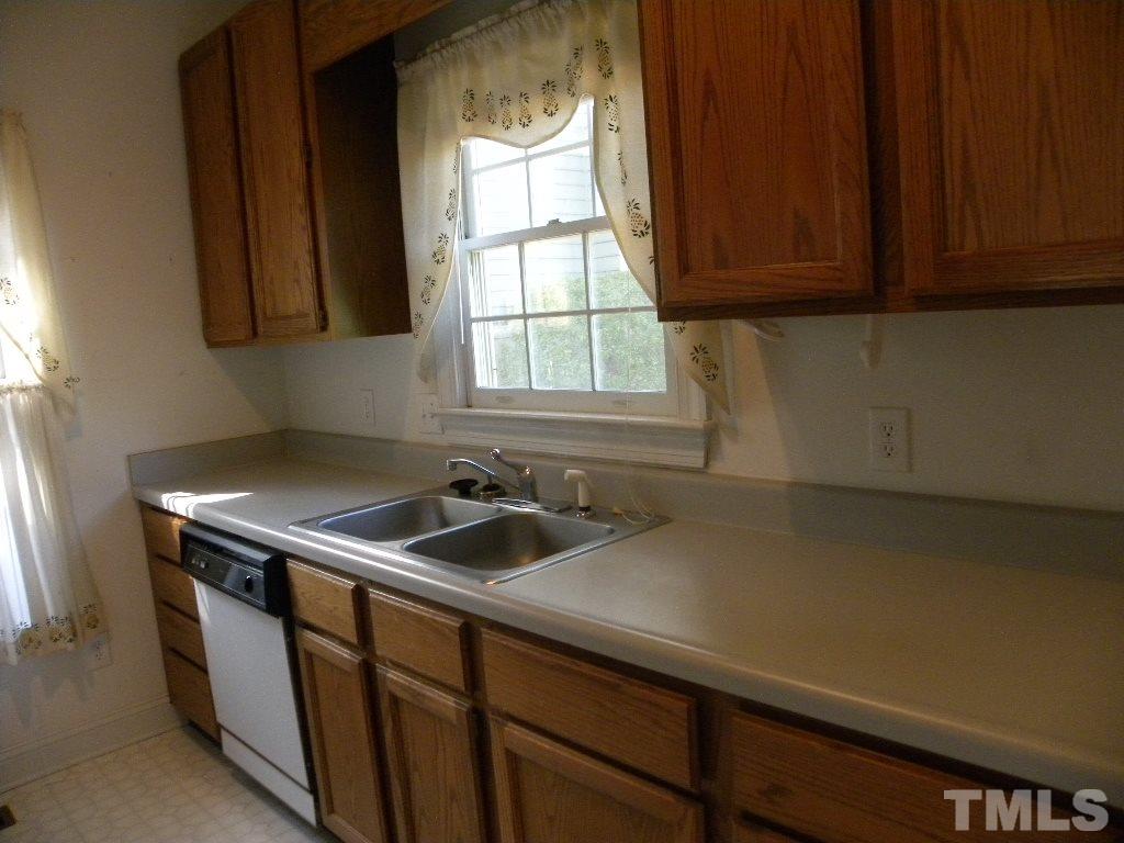 1238 Shadow Bark Court Raleigh, NC 27603 - Photo 4 of 17 a kitchen with a sink cabinets and a window