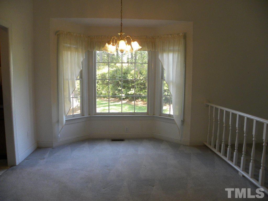 1238 Shadow Bark Court Raleigh, NC 27603 - Photo 6 of 17 a view of empty room with window and chandelier fan