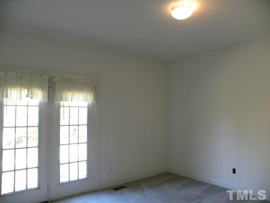 1238 Shadow Bark Court Raleigh, NC 27603 - Photo 8 of 17 an empty room with a window