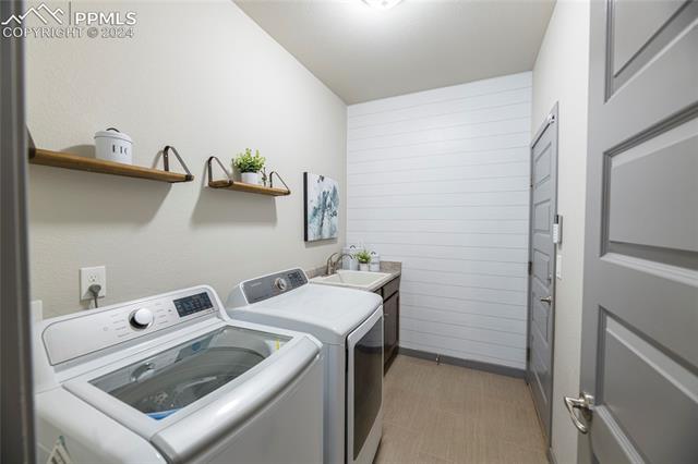 5126 Pring Ranch Road Colorado Springs, CO 80922 - Photo 18 of 32 Main-level laundry with utility sink.