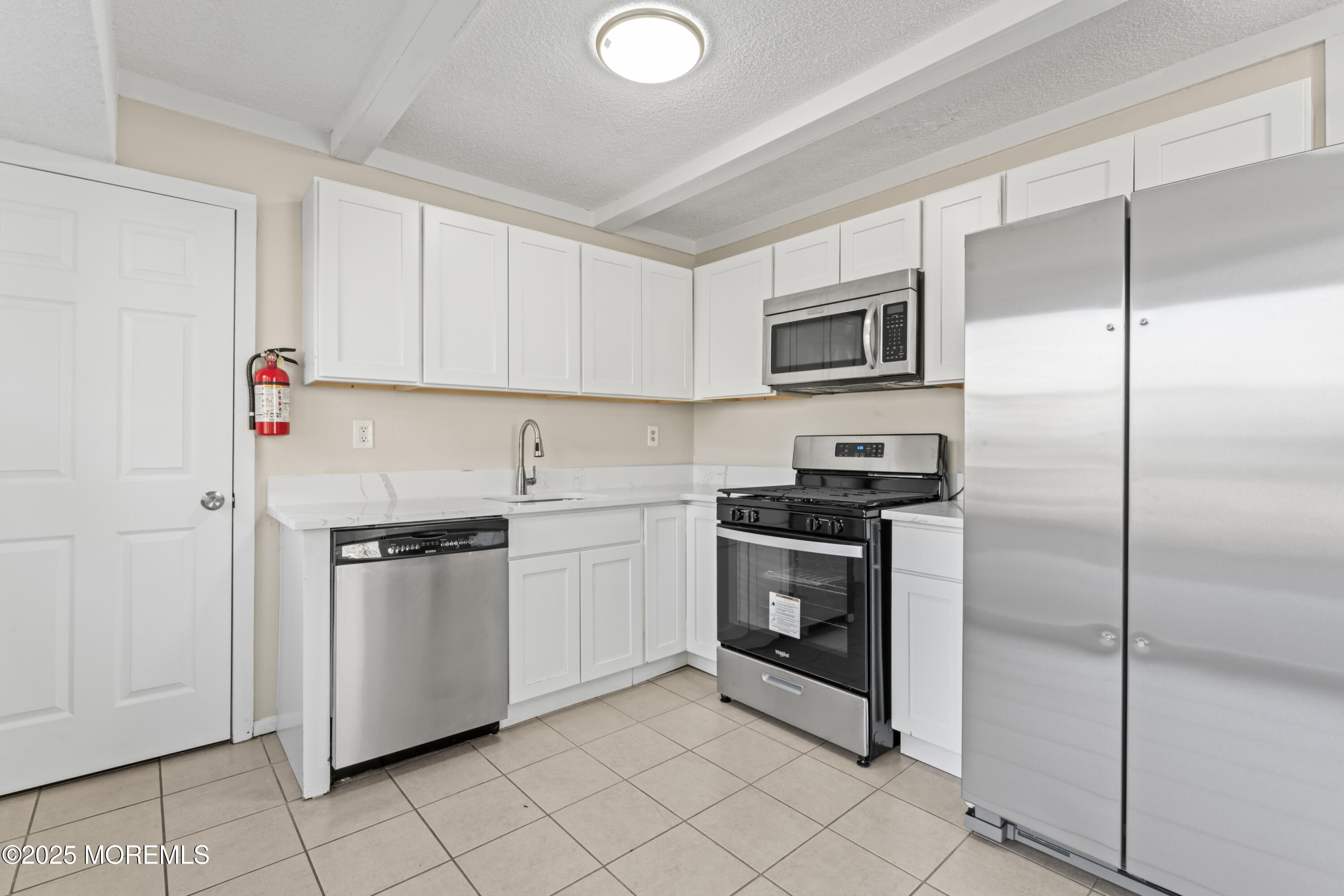 22 Anchor Road Barnegat, NJ 08005 - Photo 4 of 22 a kitchen with white cabinets and stainless steel appliances