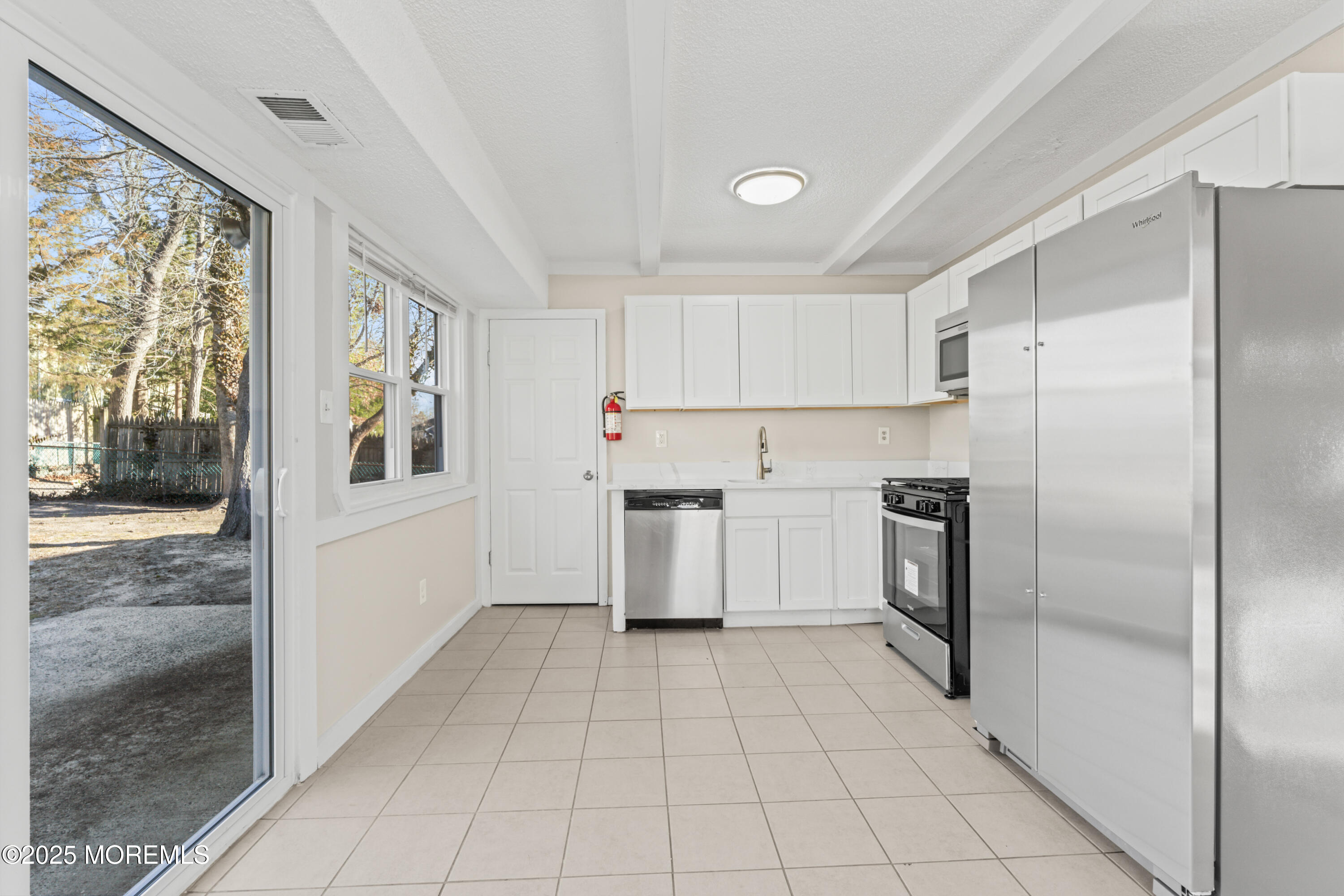 22 Anchor Road Barnegat, NJ 08005 - Photo 7 of 22 a kitchen with a refrigerator a stove top oven and a sink