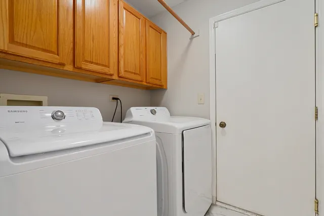 a bedroom with a bed table and a window