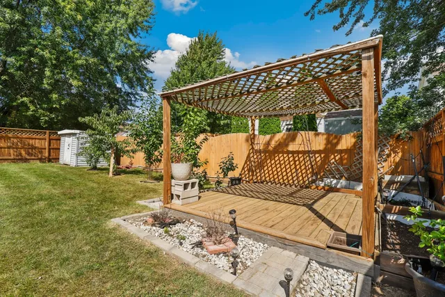 a view of a house with backyard and sitting area