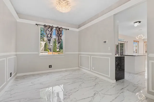 a kitchen with granite countertop a refrigerator sink stove and oven