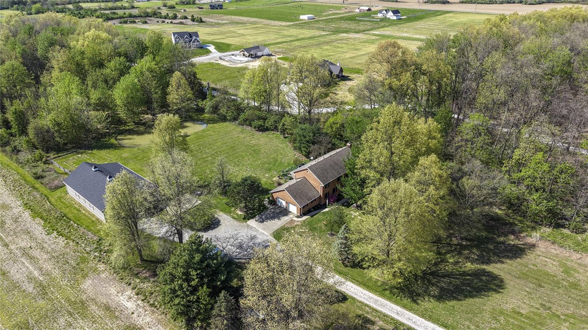 1757 Phillips Road Lebanon, OH 45036 - Photo 4 of 51 An aerial view captures the residence nestled amidst expansive green fields and mature trees.