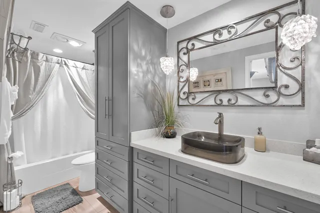 a bedroom with a bed and painting on the wall