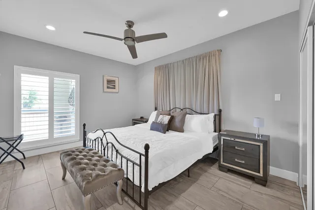 a bedroom with a bed and flat screen tv