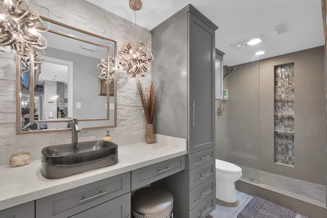 a bedroom with a bed a table and wooden floor