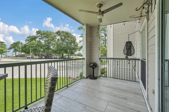 a balcony with table and chairs