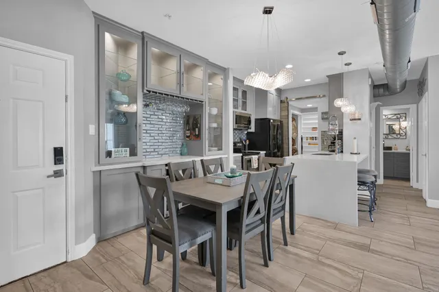 a dining room with furniture and wooden floor