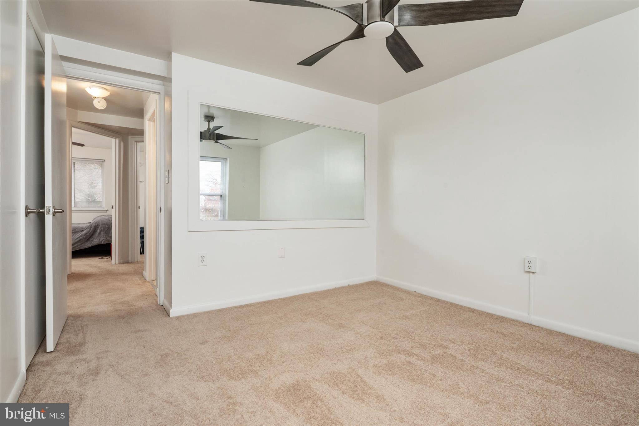 1353 Morris Road Southeast Washington, DC 20020 - Photo 16 of 32 an empty room with a mirror and a ceiling fan