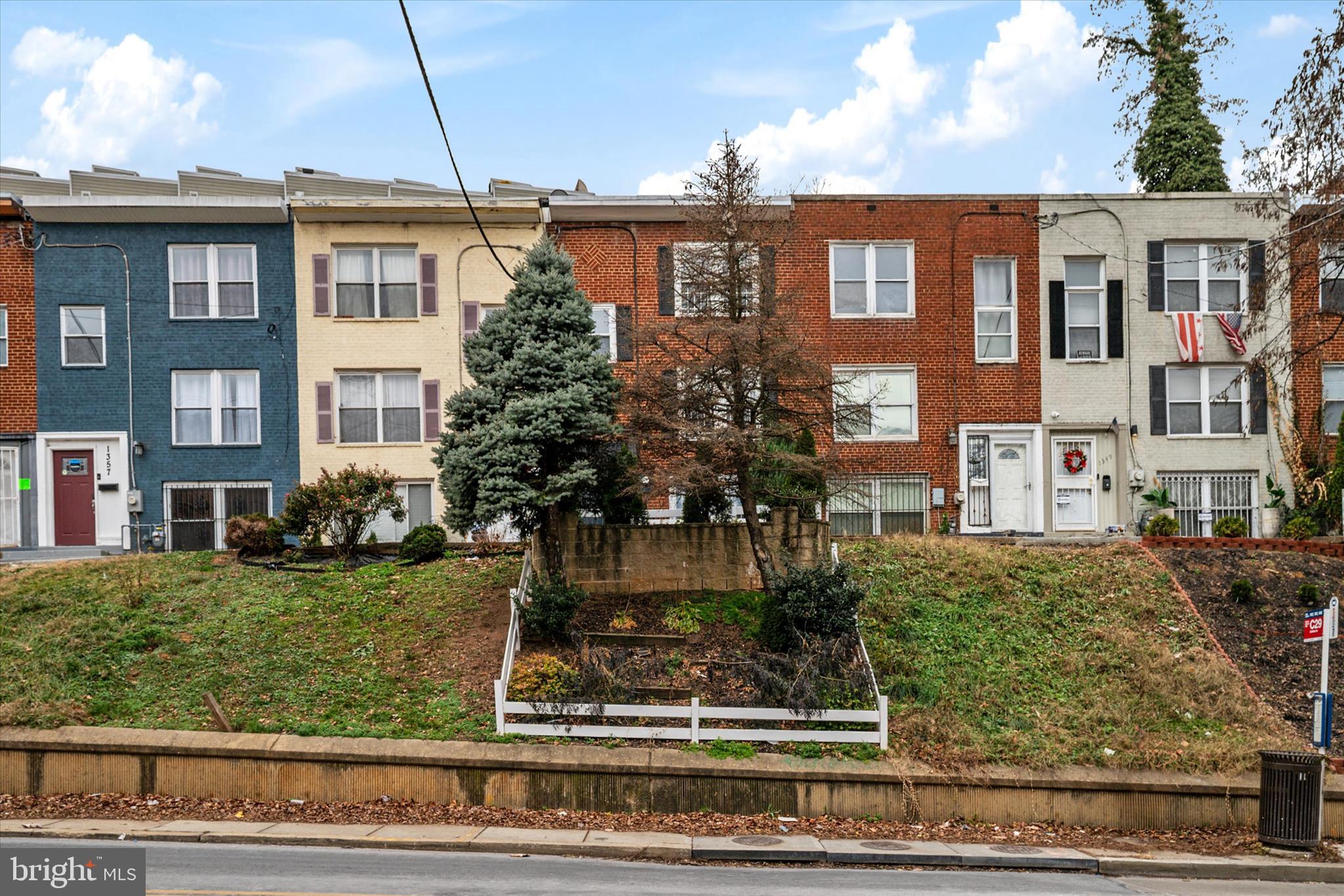 1353 Morris Road Southeast Washington, DC 20020 - Photo 2 of 32 a front view of a residential apartment building with a yard