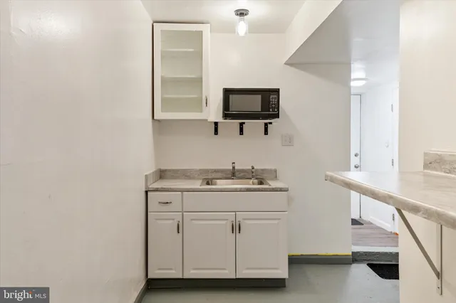 a room with a sink and a mirror