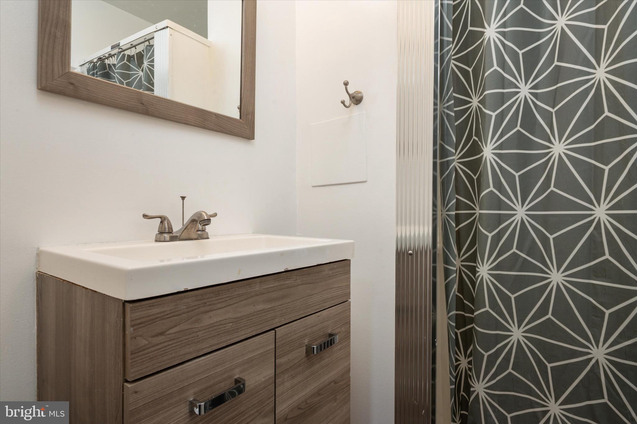 1353 Morris Road Southeast Washington, DC 20020 - Photo 25 of 32 a bathroom with a sink and a mirror