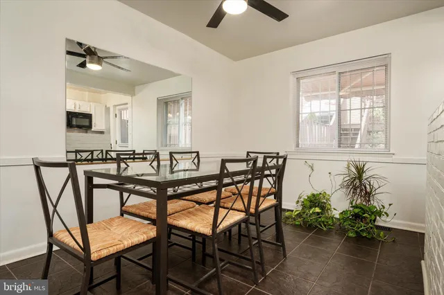 a view of a dining room with furniture and a potted plant