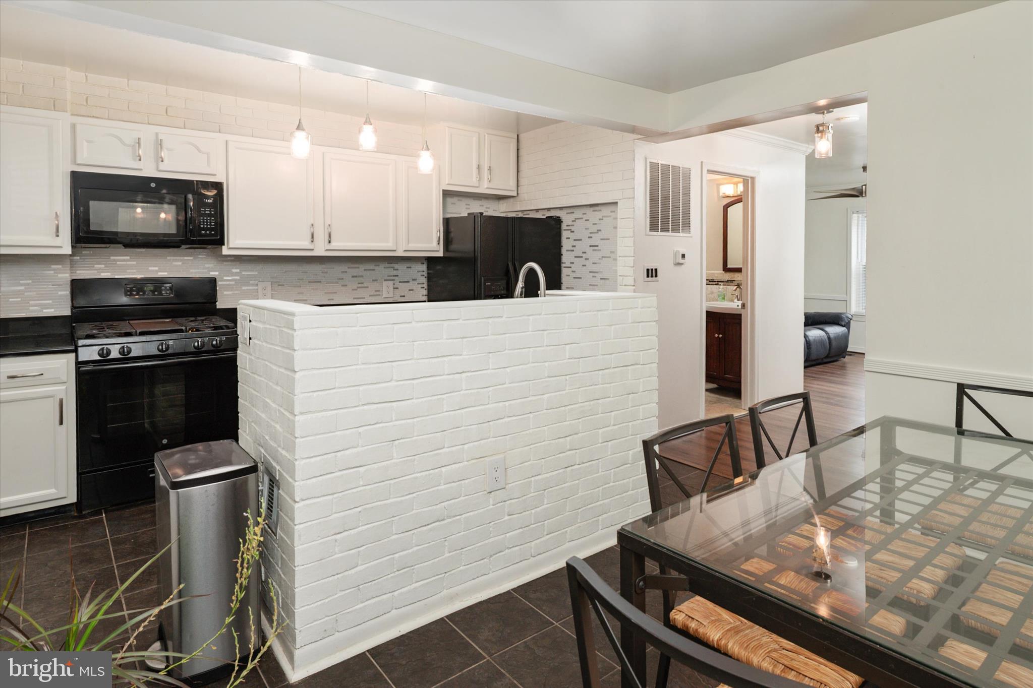 1353 Morris Road Southeast Washington, DC 20020 - Photo 10 of 32 a kitchen with stainless steel appliances kitchen island granite countertop a stove white cabinets a sink and a granite counter top
