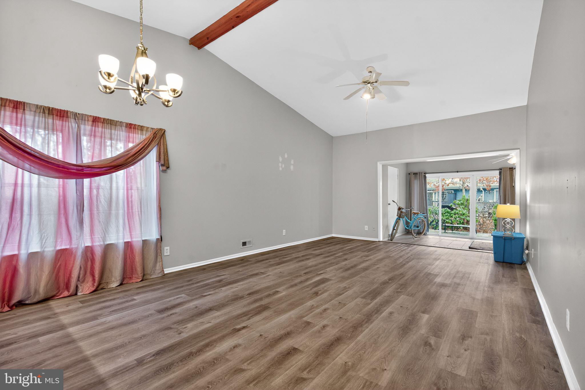 22 Club Place Absecon, NJ 08205 - Photo 11 of 37 a view of an empty room with a window and wooden floor
