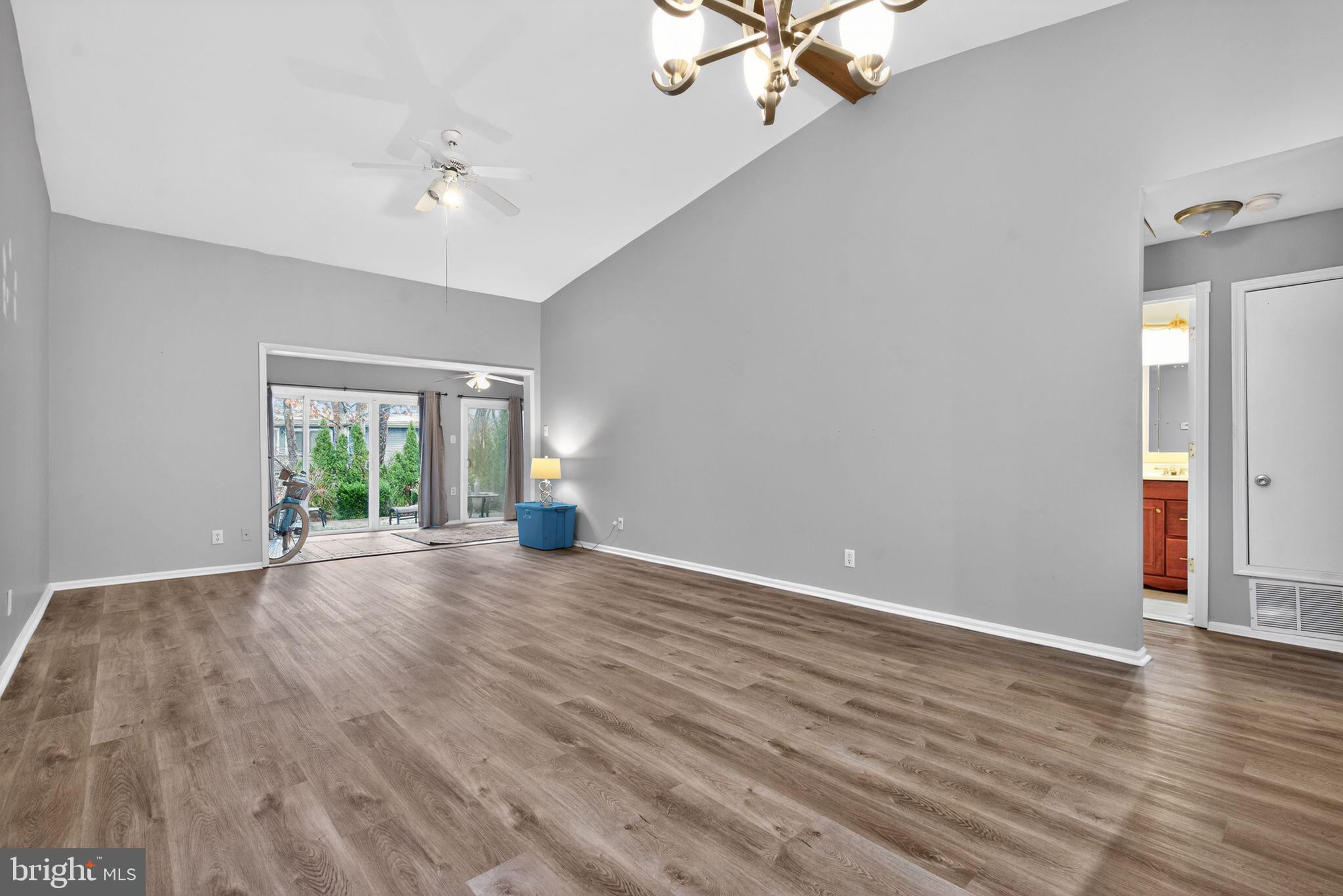 22 Club Place Absecon, NJ 08205 - Photo 13 of 37 a view of a livingroom with wooden floor and a ceiling fan