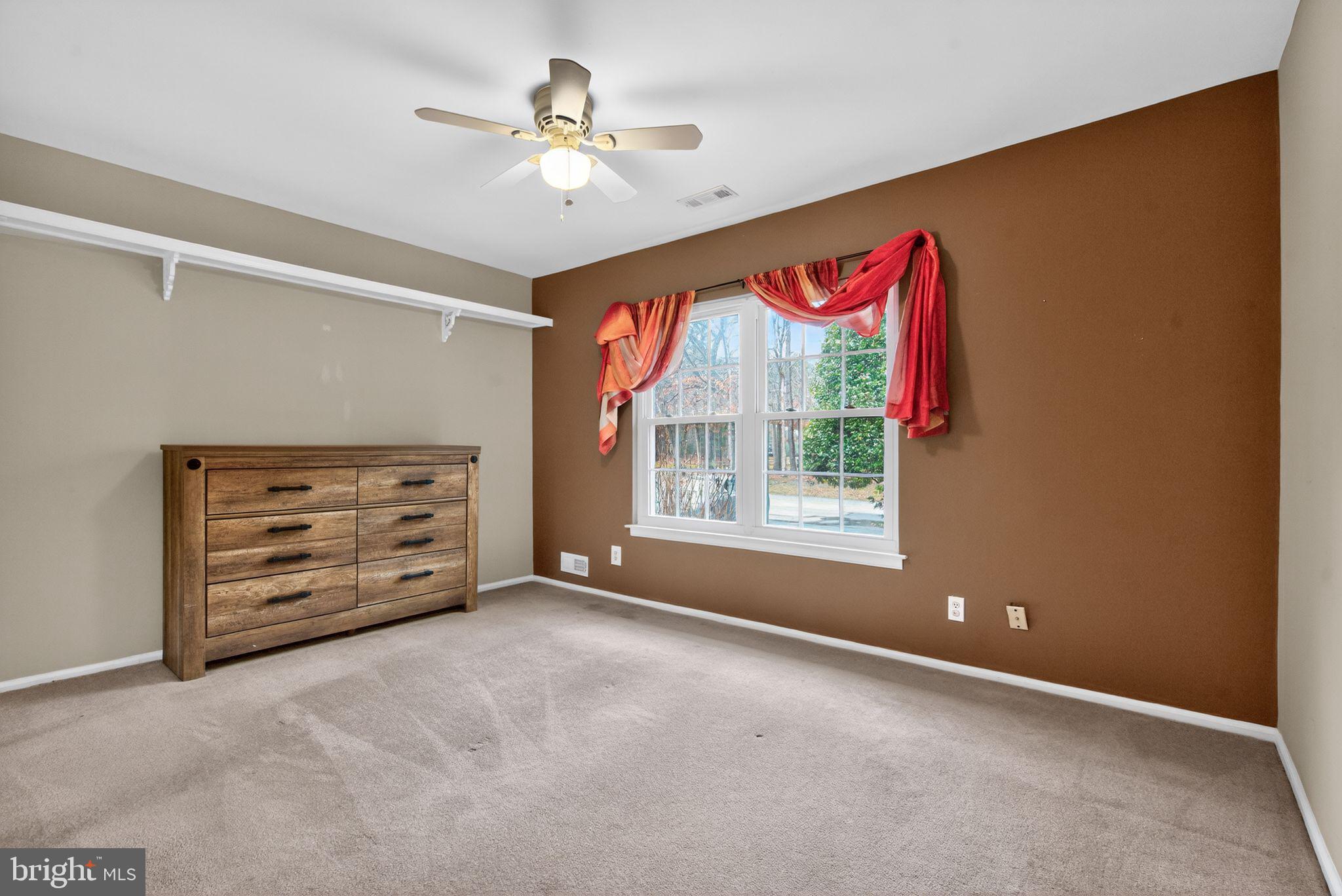 22 Club Place Absecon, NJ 08205 - Photo 17 of 37 an empty room with windows and chandelier fan