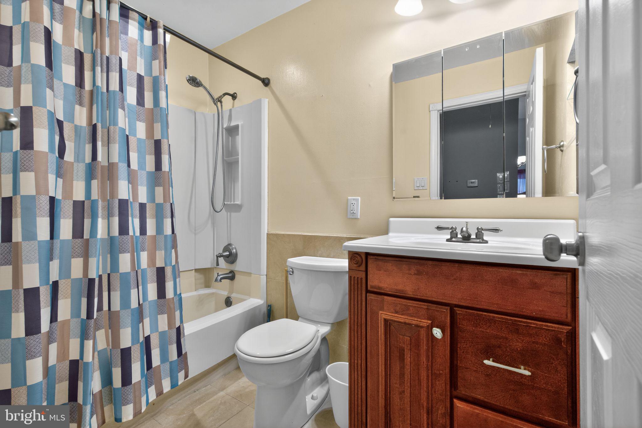 22 Club Place Absecon, NJ 08205 - Photo 19 of 37 a bathroom with a sink vanity mirror and toilet