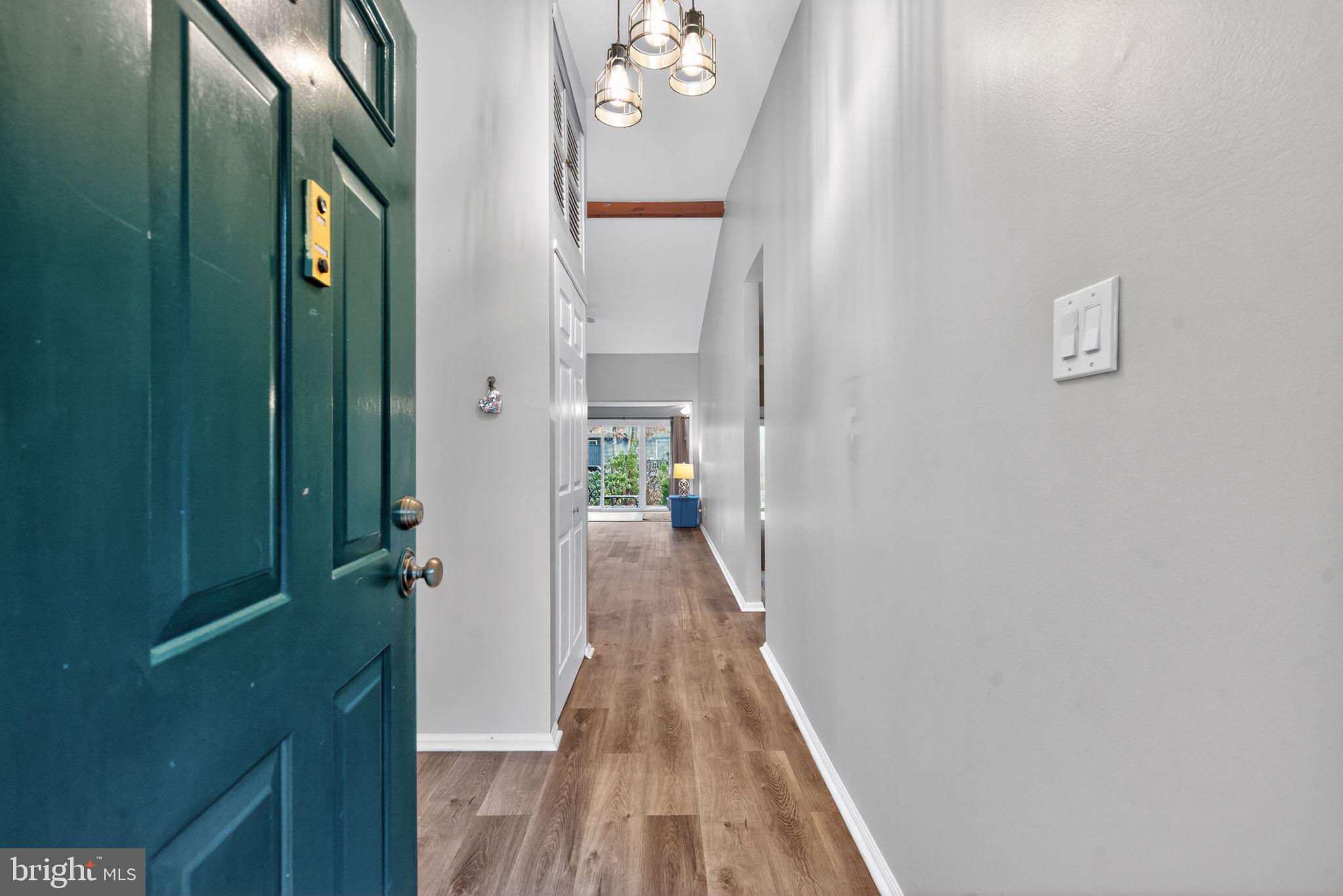 22 Club Place Absecon, NJ 08205 - Photo 2 of 37 a view of a hallway with wooden floor and staircase