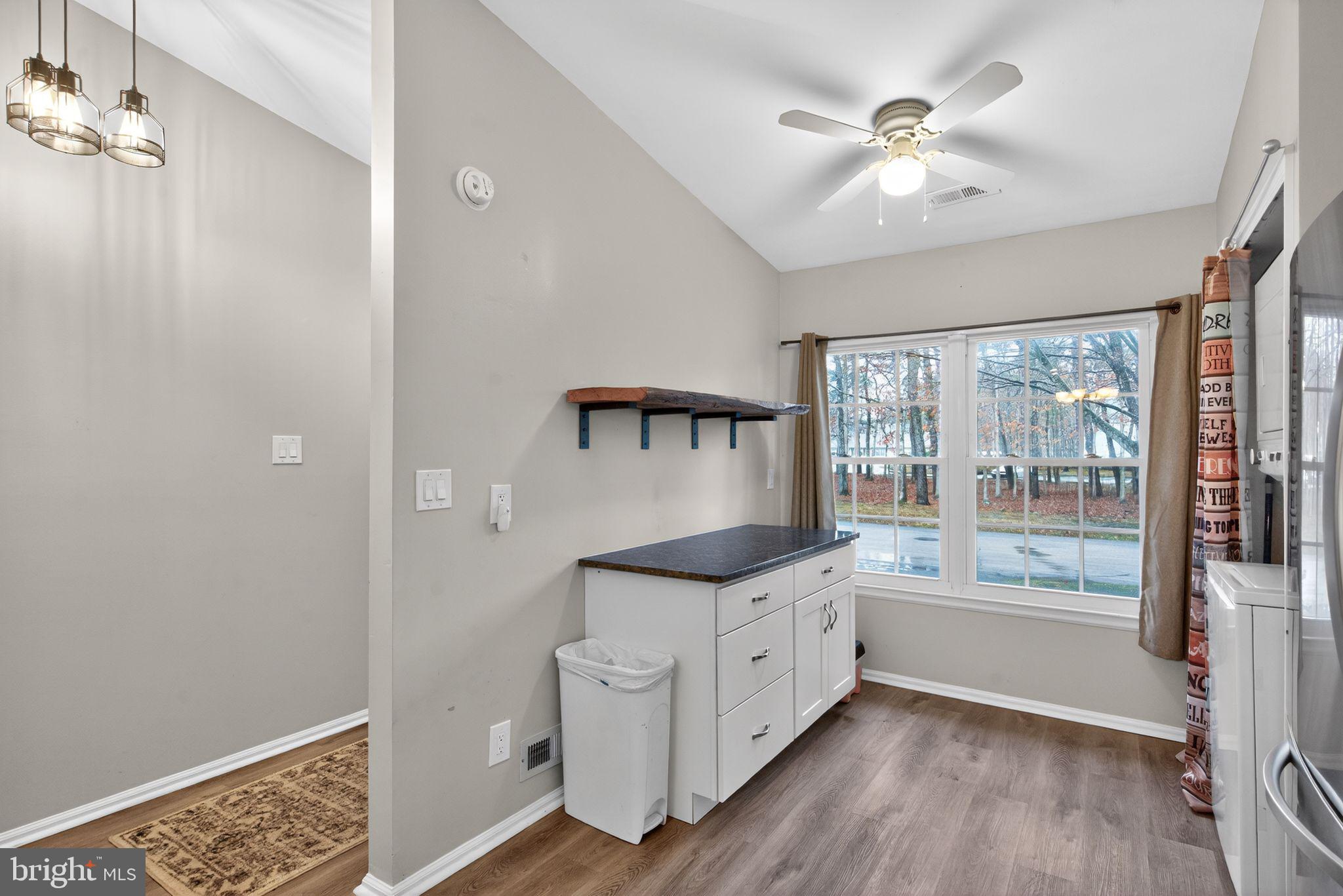 22 Club Place Absecon, NJ 08205 - Photo 21 of 37 a kitchen with stainless steel appliances granite countertop a stove a sink and a refrigerator with wooden floor