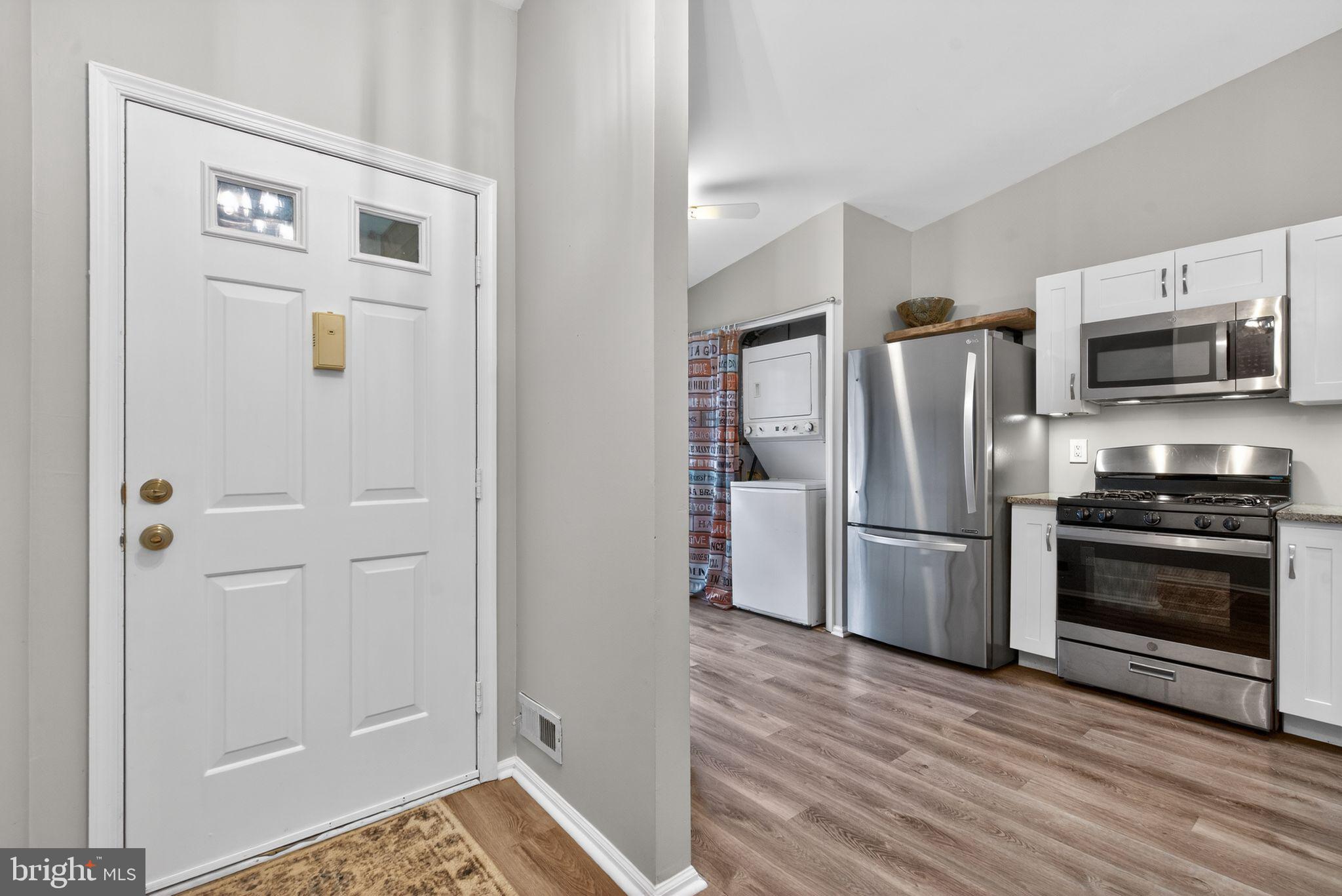 22 Club Place Absecon, NJ 08205 - Photo 3 of 37 a kitchen with stainless steel appliances a refrigerator stove and microwave