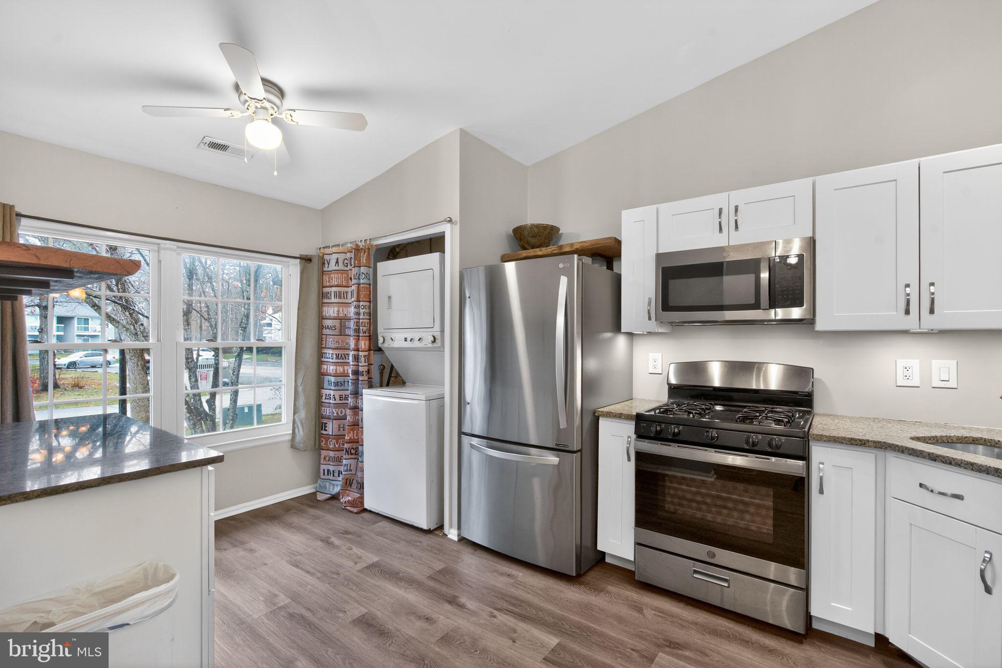 22 Club Place Absecon, NJ 08205 - Photo 4 of 37 a kitchen with a refrigerator stove and microwave