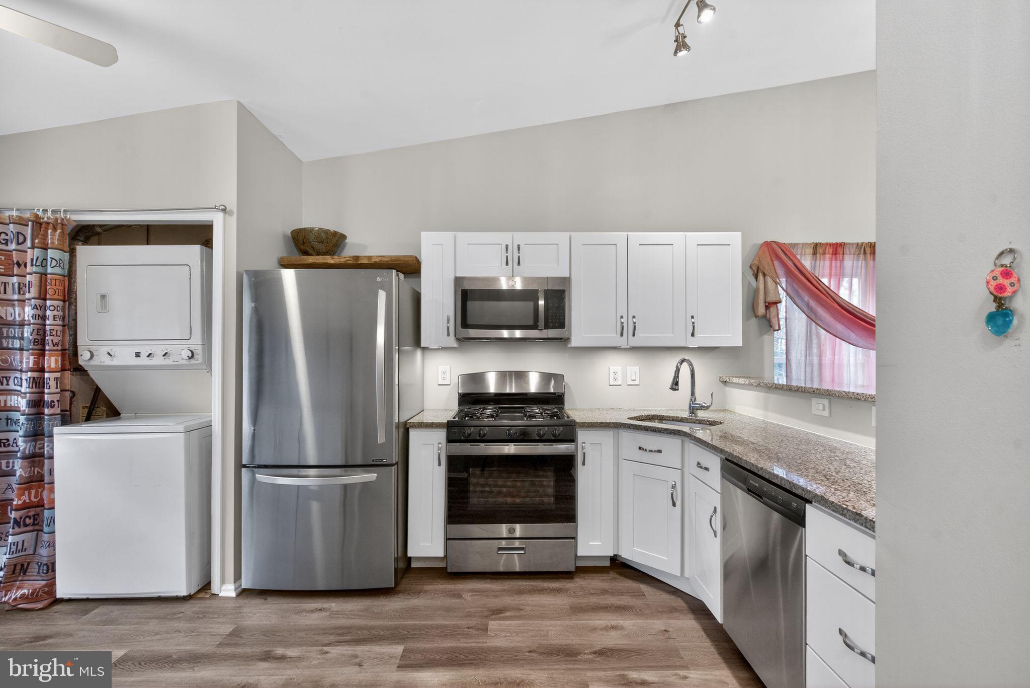 22 Club Place Absecon, NJ 08205 - Photo 5 of 37 a kitchen with a refrigerator sink and wooden floor