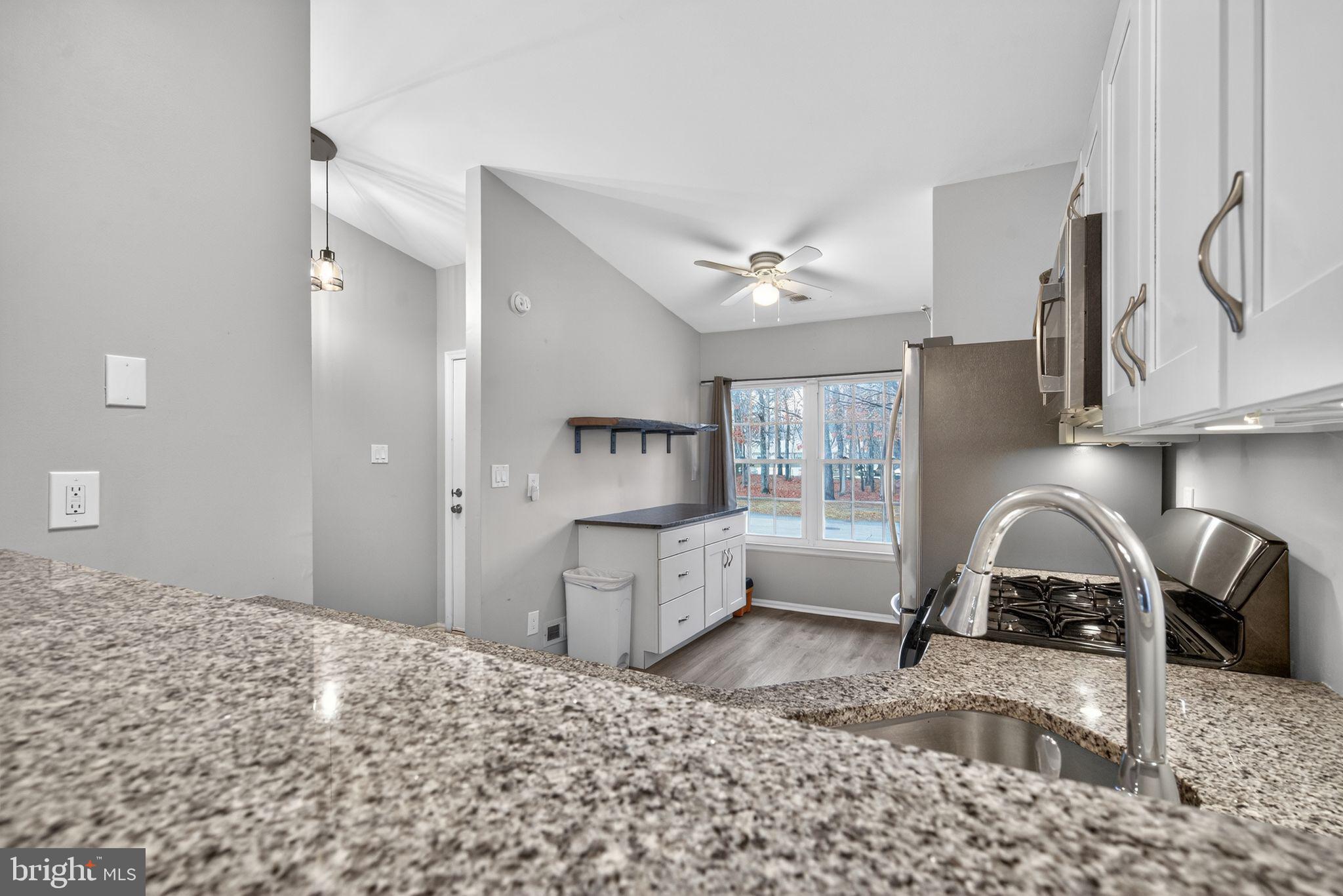 22 Club Place Absecon, NJ 08205 - Photo 8 of 37 a kitchen with a refrigerator a sink and a stove
