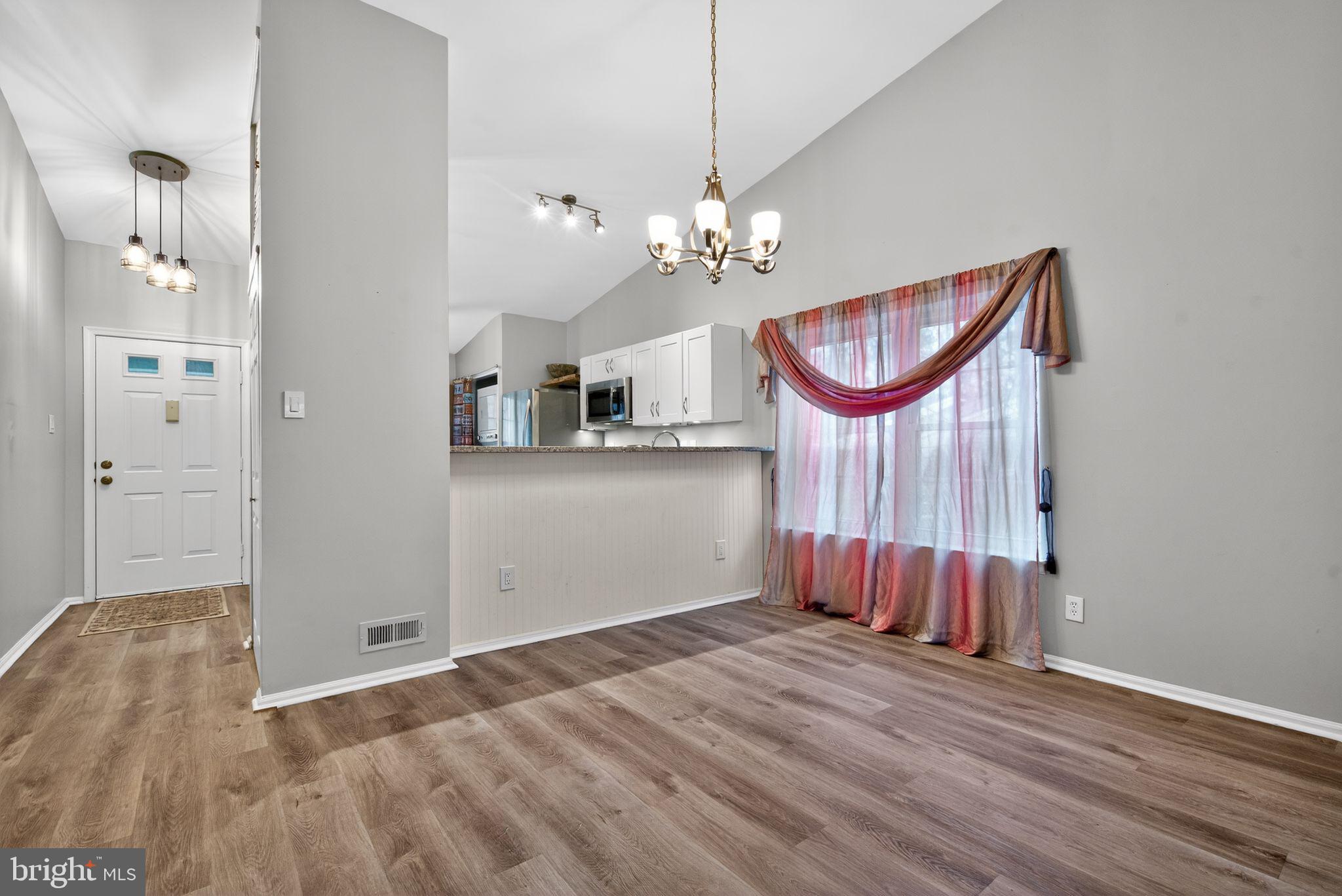 22 Club Place Absecon, NJ 08205 - Photo 9 of 37 a view of an empty room with a kitchen