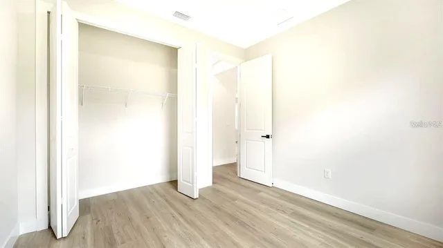 a view of a room with wooden floor