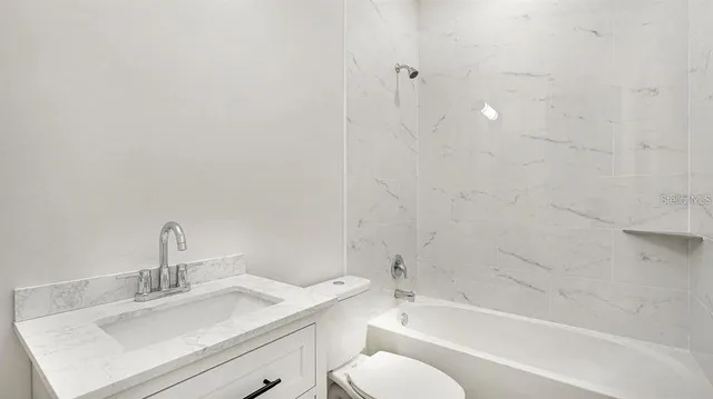 a bathroom with a sink toilet and bathtub