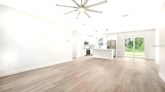 a view of a room with wooden floor and window