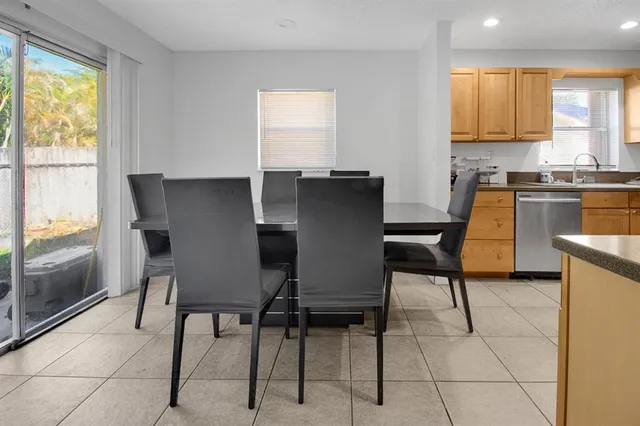 a view of a dining room with furniture and a window